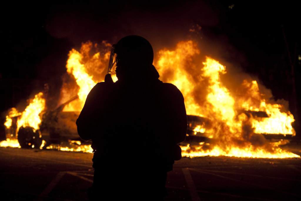 ap foto : jonathan hayward : a riot officer watches as two police cars burn during a riot in downtown vancouver, british columbia wednesday, june 15, 2011 following the vancouver canucks 4-0 loss to the boston bruins in game 7 of the stanley cup hockey final. angry, drunken revelers ran wild wednesday night after the vancouver canucks' 4-0 loss to boston in game 7 of the stanley cup finals, setting cars and garbage cans ablaze, smashing windows, showering giant tv screens with beer bottles and dancing atop overturned vehicles. (ap photo/the canadian press, jonathan hayward) / scanpix code: 436 stanley cup vancouver scene hocke automatarkiverad